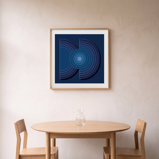 Layers Blue II framed above a round oak dining table – art print by Marcio Pontes