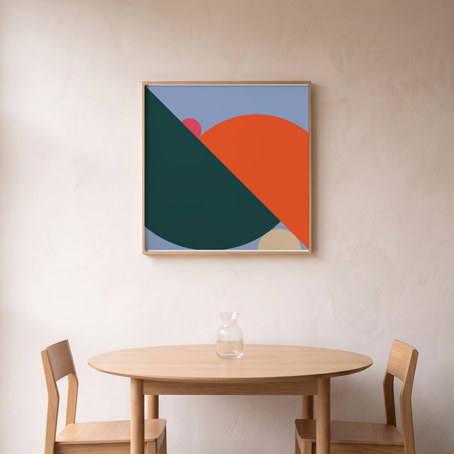 Geometry Orange II framed above a round oak dining table – art print by Marcio Pontes