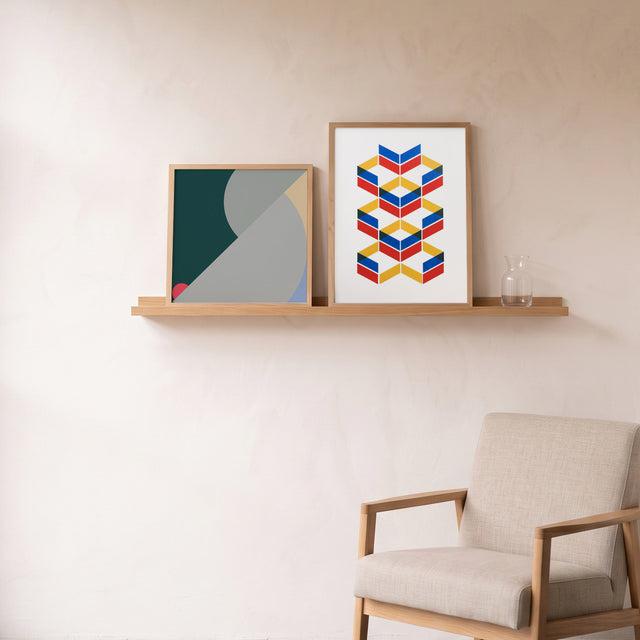 Geometry Orange I framed on an oak picture shelf beside a linen armchair – art print by Marcio Pontes