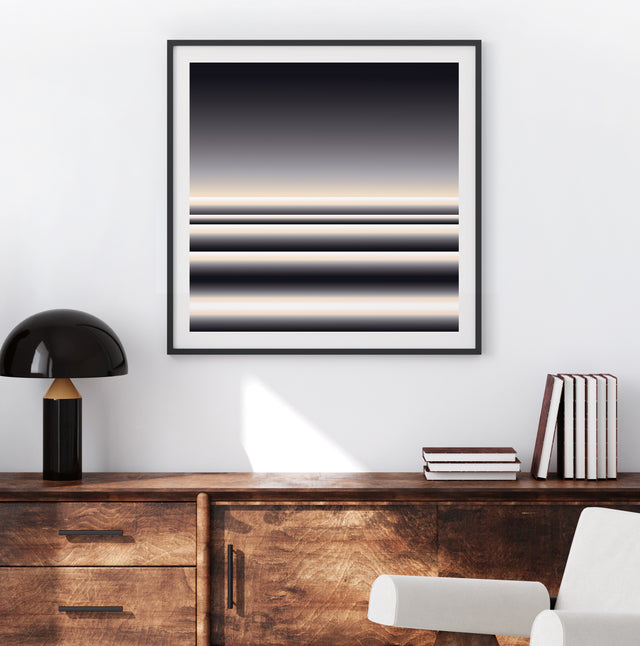 Retrocosmos Lunar 1 framed above a wooden sideboard in sunlight – black and cream art print by Marcio Pontes