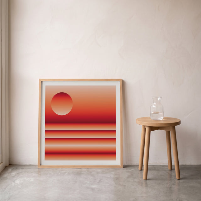 Retrocosmos Sunset 2 framed leaning against the wall on a concrete floor – art print by Marcio Pontes