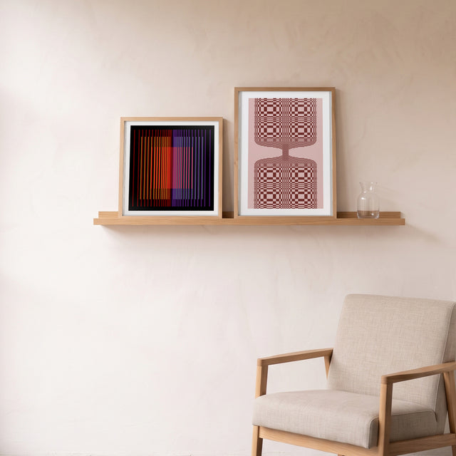 Underline Bold I framed on an oak picture shelf beside a linen armchair – art print by Marcio Pontes