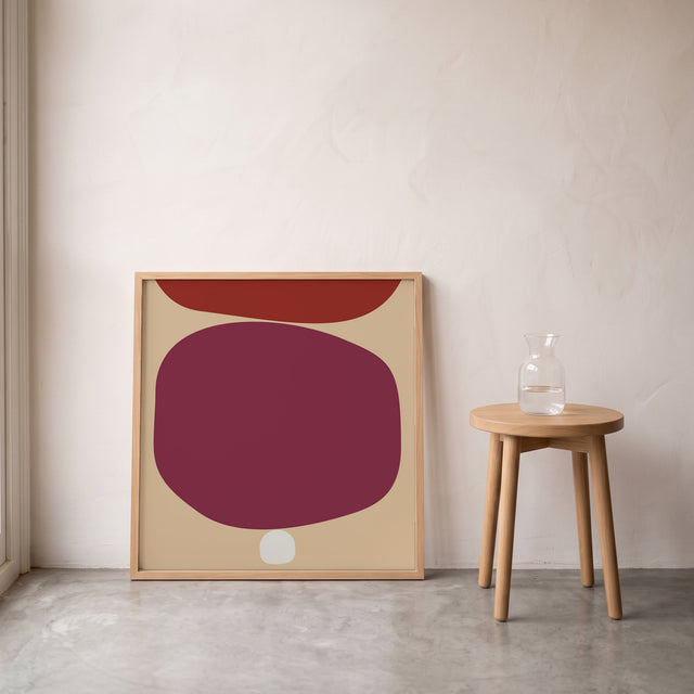 Stones Soft Purple framed leaning against the wall on a concrete floor – art print by Marcio Pontes