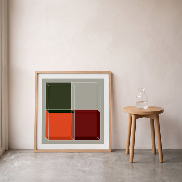 Cube Colors framed leaning against the wall on a concrete floor – art print by Marcio Pontes
