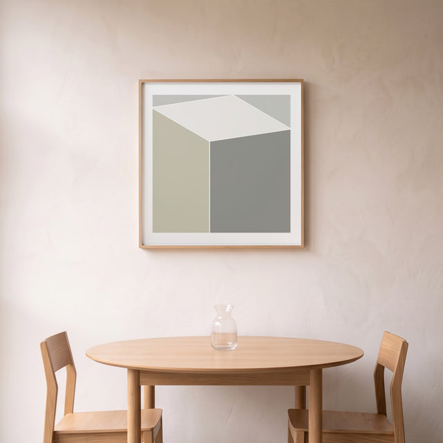 Cube Minimal framed above a round oak dining table – art print by Marcio Pontes