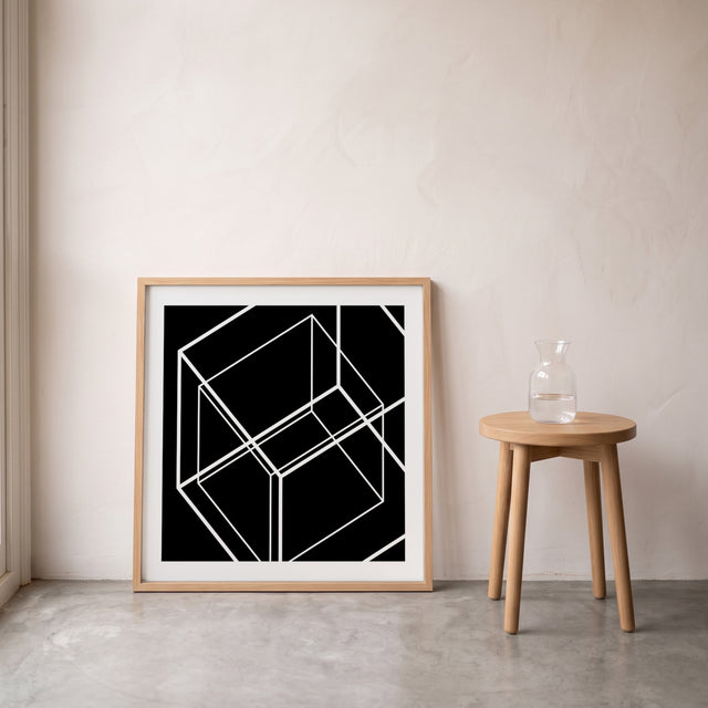 Cube in the box II framed leaning against the wall on a concrete floor – art print by Marcio Pontes
