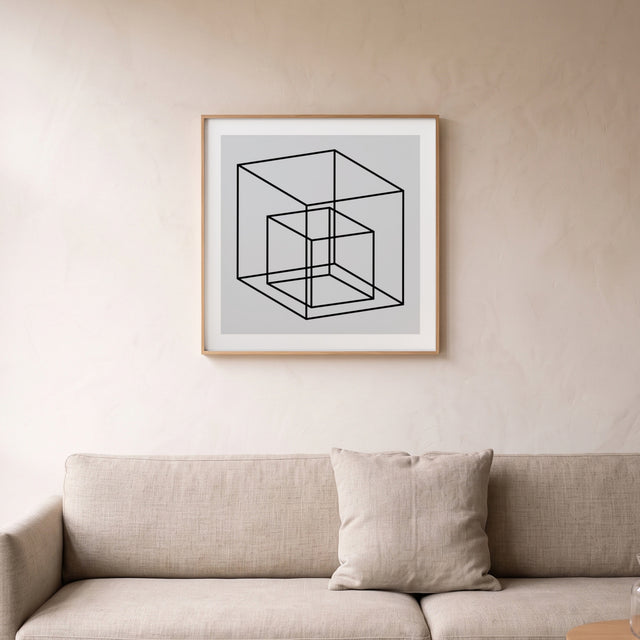 Cube in the box I framed above a linen sofa – art print by Marcio Pontes