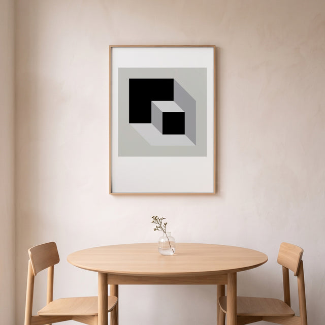 Cube Sliding I framed above a round oak dining table – art print by Marcio Pontes