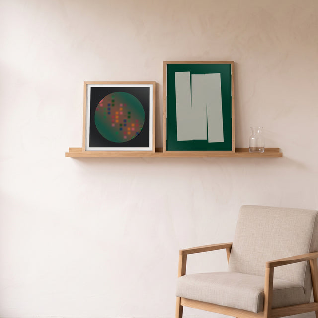 Geo Lines D framed on an oak picture shelf beside a linen armchair – art print by Marcio Pontes