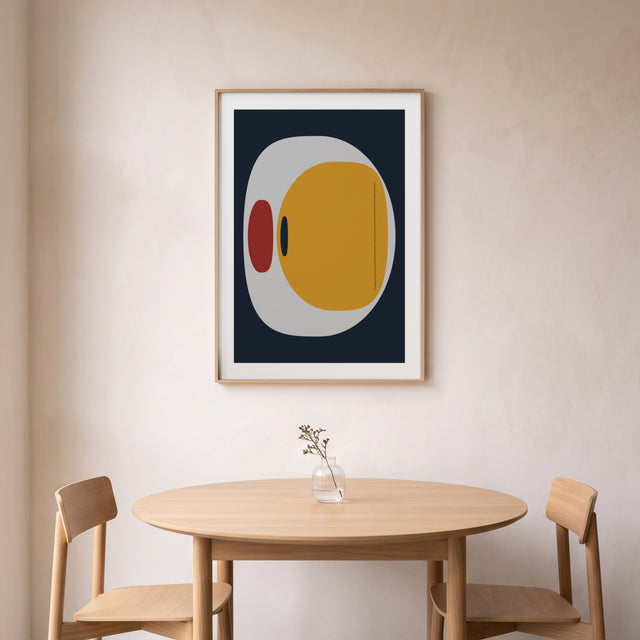 Stones I framed above a round oak dining table – art print by Marcio Pontes
