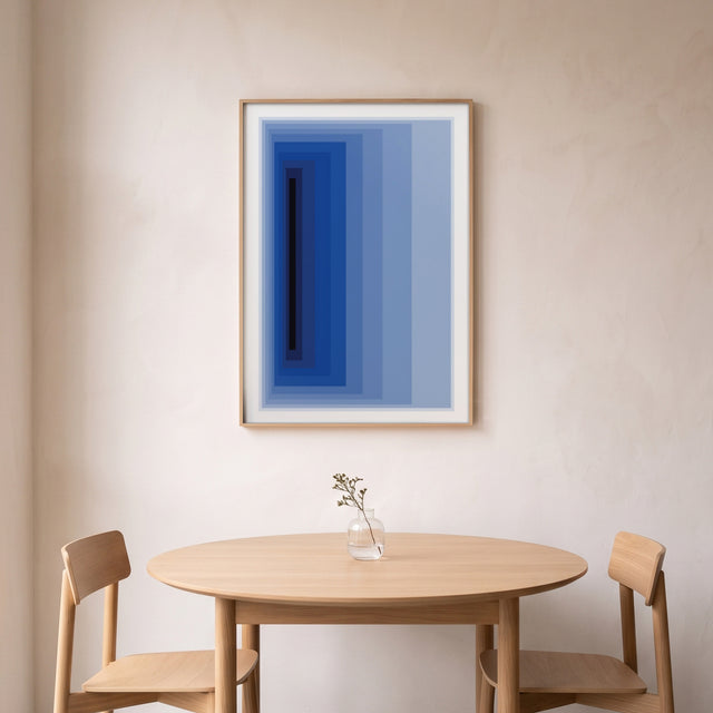 Minimal Blue framed above a round oak dining table – art print by Marcio Pontes