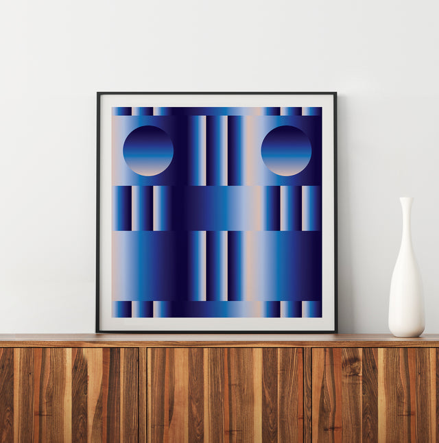 Retrocosmos Blue 2 framed and leaning on a walnut sideboard – navy and cobalt art print by Marcio Pontes