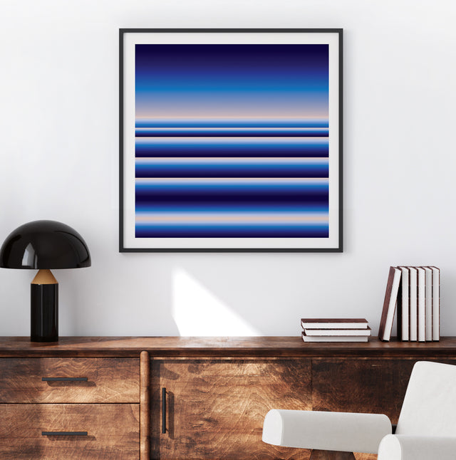 Retrocosmos Blue 1 framed above a wooden sideboard in daylight – navy and cobalt art print by Marcio Pontes
