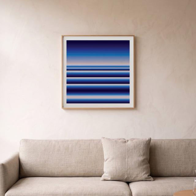 Retrocosmos Blue 1 framed above a linen sofa – art print by Marcio Pontes