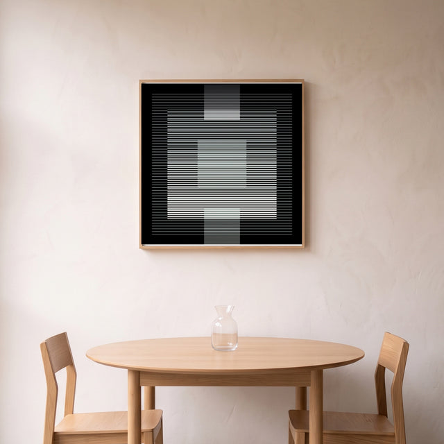 Underline Black framed above a round oak dining table – art print by Marcio Pontes