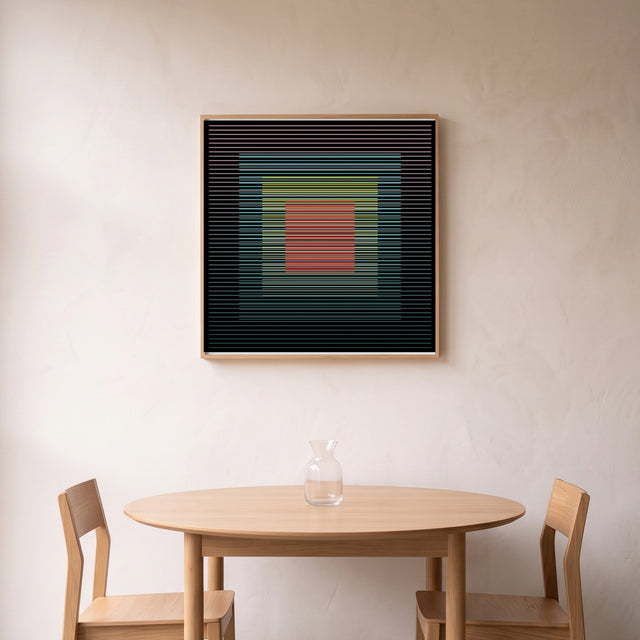 Underline 7 framed above a round oak dining table – art print by Marcio Pontes
