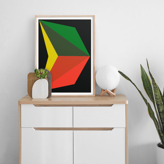 White cabinet with handmade artwork designed with large graphics in dark green, citrus yellow, and red on black background and wood frame.